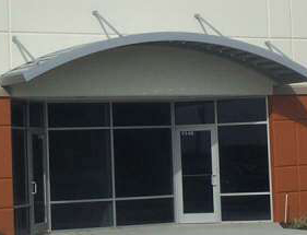 arched aluminum suspended canopy above business entrance